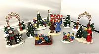 Group shot of entire lot showing all 13 miniature holiday village accessories