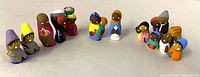 All 17 painted Haitian clay Nativity figures arranged in arc