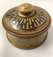 Closed stoneware casserole showing lid decoration and overall finish
