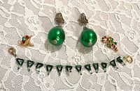 Group view of bracelet, earrings and two lapel pins