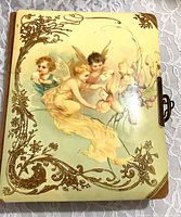 Front cover showing cherub illustration and clasp