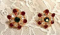 Front view of rhinestone clip earrings showing red, clear and green stones