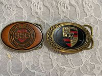 Front view of both Porsche buckles showing crest and 356 designs