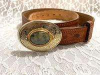 Full view of tooled leather belt with buckle