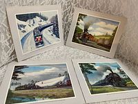 Fronts of four Howard Fogg train prints on freestanding mounts