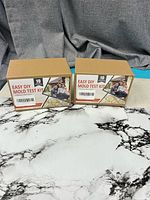 Two sealed Easy DIY mold test kit boxes front view