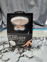 Front of sealed Finishing Touch Flawless Legs retail box