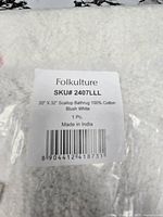 Label showing brand Folkulture, SKU 2407LLL, size 20" x 32", material 100% cotton, blush white, made in India