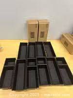 All 10 drawer organizer trays arranged plus two unopened boxes