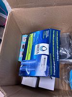 Open box showing Brita Elite filter packaging and other items
