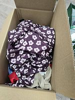 Top view of box showing purple floral garment