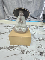 Front view of ceramic monk tea infuser on box