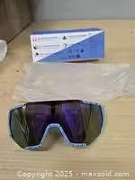 Front view of Queshark youth sports sunglasses with box and sleeve