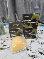 Front view of three Nimiah Double Side Sticky Bra Inserts boxes with one unpacked insert visible