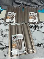 Three Hesanzol baguette pans stacked on table