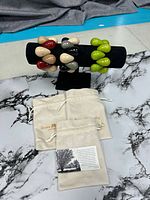 All three bracelets displayed on stand plus dust bags