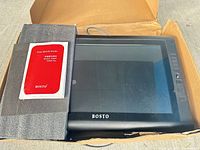 Tablet, manual, foam padding and cable inside box