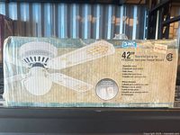 Boxed SMC 42 inch decorative ceiling fan showing product image and specifications
