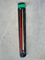 Two-piece pool cue laid in black soft case