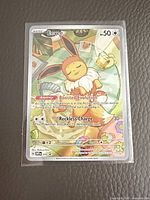 Front view of sleeved prismatic holo Eevee promo card