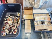 Wide view of tote with loose cards, divider box with rows of cards and small box