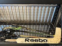 Hockey stick and lacrosse stick on rack