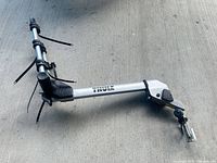Overall view of Thule aluminum bike rack arm showing straps, cradle and mounting clamp
