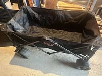 Overall view of black folding wagon in open position