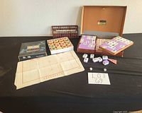 Full lot overview showing mahjong case open, xiangqi set, abacus, dice, score sheet