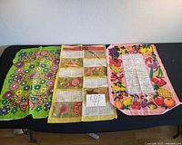 Three tea towels laid out side-by-side on table