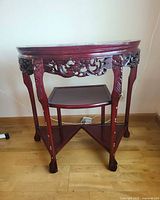 Full view of demi-lune side table showing shape, shelves, legs