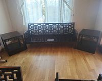 Sofa centered between two end tables showing overall design and condition