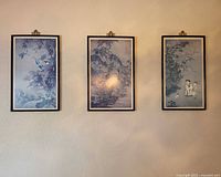 Three framed Asian prints hanging