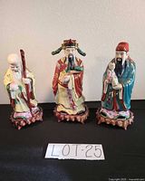 Group view showing centre and neighbouring figurines; identifies the item within a trio and overall scale