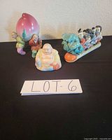 All three porcelain figurines on table