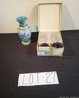 Large blue floral cloisonné vase beside open box containing stands