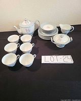 Full set showing teapot, sugar bowl, creamer, six cups and stacked plates