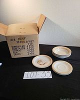 Box with listing of 20-piece set and stacked plates