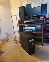 Two Dell towers, HP monitor, speakers, HP printer on wooden desk