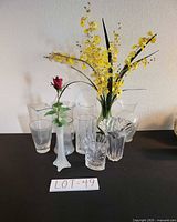 Group shot of 11 glass vases on black surface