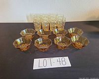 Group shot of 10 amber bowls and 6 textured tumblers