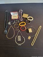 All jewelry pieces laid out on dark surface