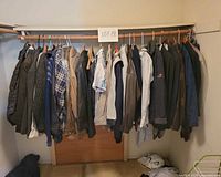 Full view of clothing lot hanging on closet rod