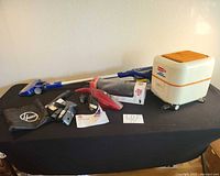 Overview of vacuums, floor head, wand, bag, attachments on table