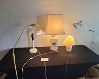 Front view showing five lamps arranged on table