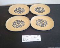 Four matching tan and blue oval platters front view