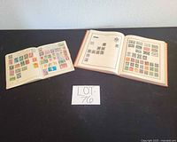 Two open stamp albums displaying mounted stamps