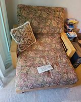 Top view of futon chaise showing upholstery, wooden arms and pillow