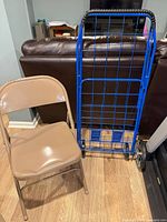 Front view of chair next to folded shopping cart
