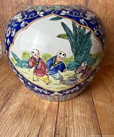 Front view showing children scene and blue scrollwork